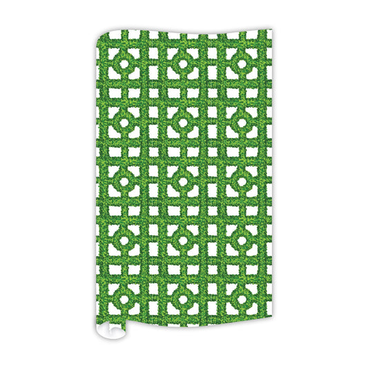 The Boxwood Trellis Gift Wrap displays a green and white geometric pattern with a grid layout and circular elements, elegantly extending over an 8 ft long continuous paper roll. Its overall appearance is reminiscent of an ornamental textile or decorative material with intricate detailing.