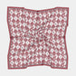 The Gameday Scarf - Crimson & Grey Checkerboard is elegantly displayed, featuring a patterned design in red and white with small illustrations within diamond shapes. Ideal as a stylish Montreal hair scarf, its edges are adorned with a solid red border that adds a touch of sophistication to any outfit.