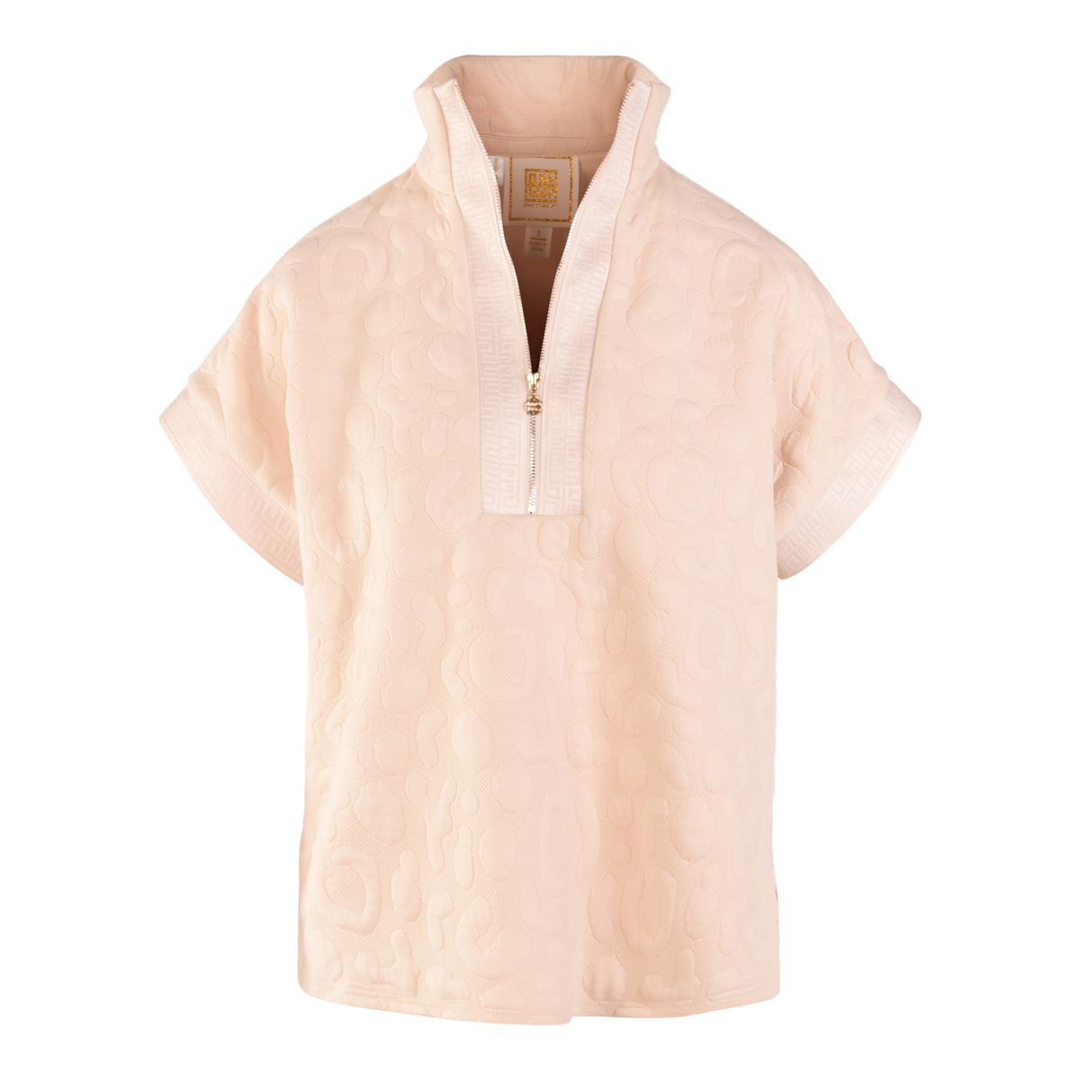 The Poppy Pullover is a light pink top with a textured, embossed cheetah pattern, short cuffed sleeves, a half-zip front, and a stand collar. Its soft, cozy fabric makes it pop against the black background.