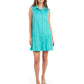 A woman wearing the Daisy Dress - Chain Jacquard, a sleeveless teal classic shirt dress with a collar, stands against a white background. She looks forward and pairs it with beige platform sandals, exuding a versatile style perfect for any occasion.