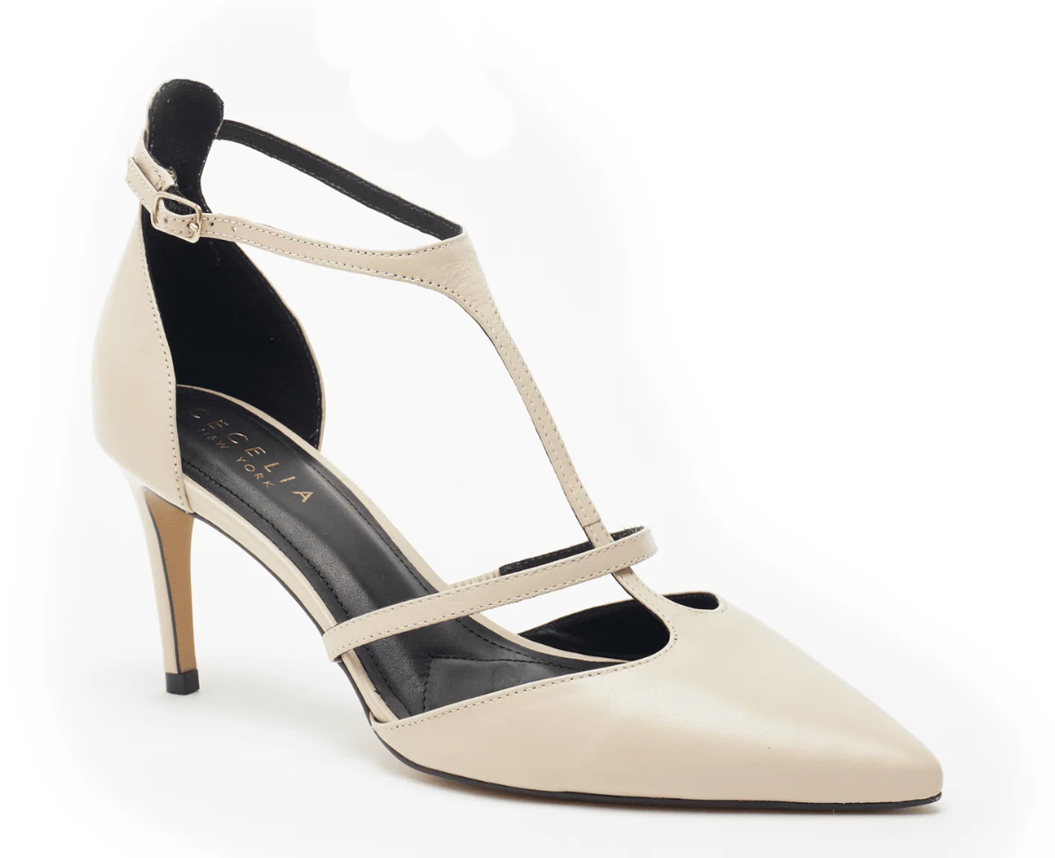 The Crawford Heel - Beige Lizard features a medium-height stiletto heel, a pointy toe, and two straps: one along the top and a T-strap leading to an ankle buckle. The insole is black for added contrast.