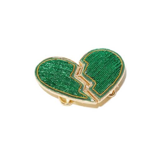 The "Don't Go Breaking My Heart Belt - Green" features a striking broken heart design, embellished with shimmering green beads and highlighted with gold accents, creating an eye-catching statement piece. Its glittery, elegant design guarantees it to be a standout accessory.