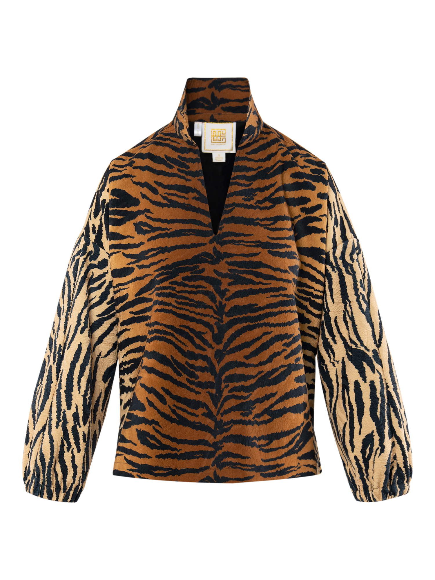 The Long-sleeve Poppy features a bold tiger jacquard in brown, black, and beige, inspired by vintage Italian interiors, with a high collar, V-shaped neckline, puffy sleeves, and a straight hem.