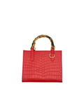 The Clara Mini - Red is a small red crossbody bag with a crocodile-texture pattern, two curved bamboo-style handles, premium goat skin, and a gold metal accent near one handle for an elegant touch.