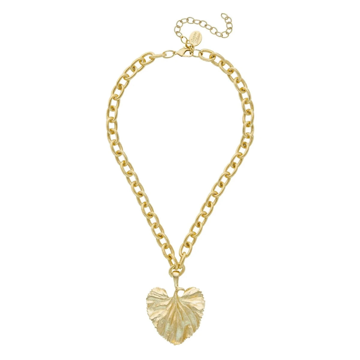 The Gold Scalloped Leaf Chain necklace features a gold chain embellished with a prominent, textured leaf-shaped pendant. This exquisite piece includes an adjustable clasp and a small round tag, showcasing elegance and charm.