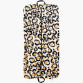 The Gulf Stream Garment Bag - Classic Spot Cheetah boasts a striking design featuring black spots outlined in gold and brown on a cream background. It is fully zipped and includes two handles for easy carrying, offering a perfect combination of style and functionality for your travels.