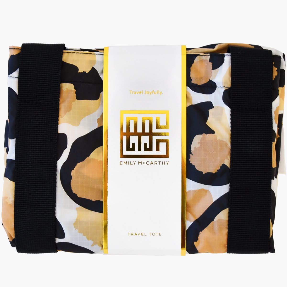 The Travel Tote - Classic Spot Cheetah showcases a chic design with stylish black straps, elegantly displayed in branded white and gold packaging labeled Emily McCarthy.