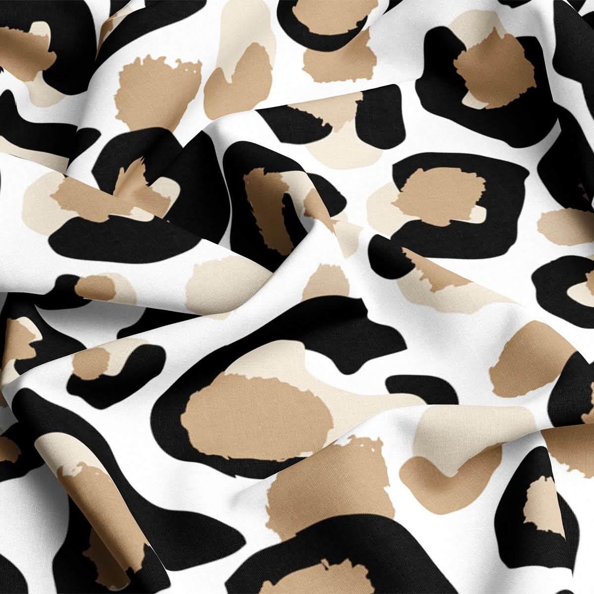 A close-up of the Fabric by the Yard - Classic Cheetah reveals its upholstery material with a striking cheetah print design. This cotton and linen blend exhibits irregular black and brown spots set against a white backdrop, enhancing its textured look through subtle folds in the fabric.