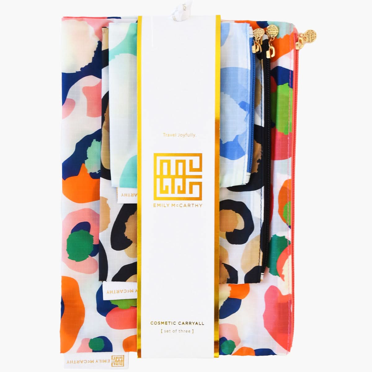 Introducing the Cosmetic Carryall Set - Cheetah Mix, a vibrant trio of cosmetic bags featuring abstract patterns in blue, orange, pink, and green. These stylish carryalls are bundled together with a label that proudly showcases Emily McCarthy's name. They are perfect for infusing your travel essentials with a splash of color.