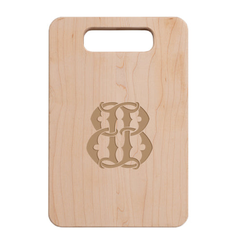 A 1-Letter Monogrammed Artisan Board featuring a handle at the top and a detailed, symmetrical design engraved in the center. The board showcases a light, natural wood grain finish, making it an ideal gift for any occasion.