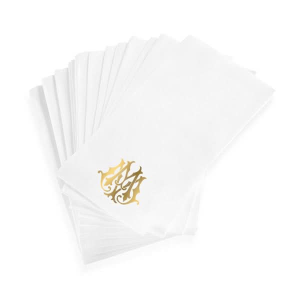A stack of 1-Letter Monogrammed Guest Towels, elegantly white with a linen texture and a decorative gold monogram in one corner.