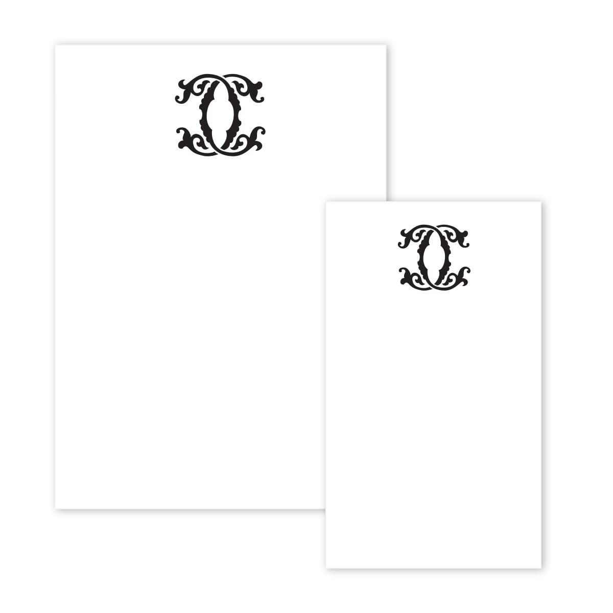 The Gift Bar Notepad Set includes two pieces of white stationery adorned with decorative black ornate designs at the top, reminiscent of elegant notepads. The intricate swirls and symmetrical patterns lend a touch of sophistication, with the sheets differing in size and the larger one gracefully positioned on the left.