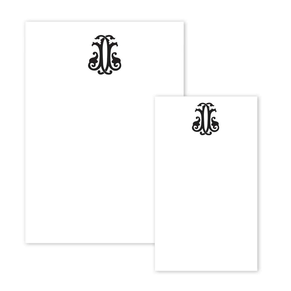 The Gift Bar Notepad Set includes two sheets of plain white notepad paper, each adorned with an ornate black monogram at the top center. The elegant swirling designs enhance the minimalistic layout, adding a decorative touch to elevate the art of lettering.