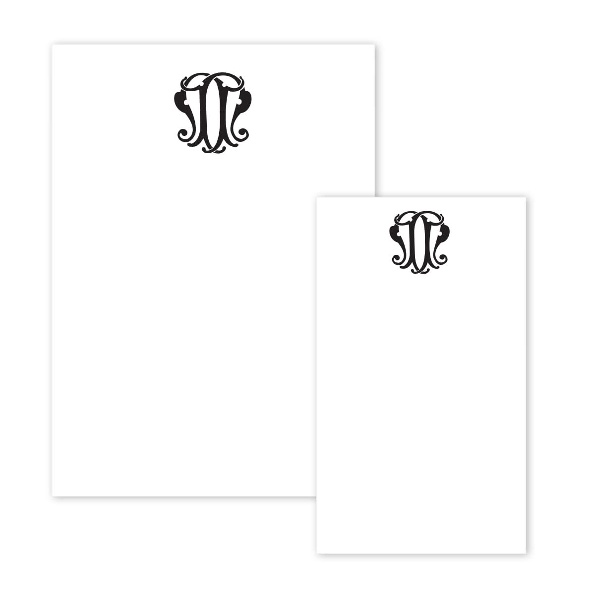 In the Gift Bar Notepad Set, an elegant black monogram adorns two sheets of white notepad paper. The larger sheet is positioned on the left, and the smaller one on the right. This sophisticated monogram showcases intricately intertwined lettering, evoking a timeless sense of artistry and refinement.