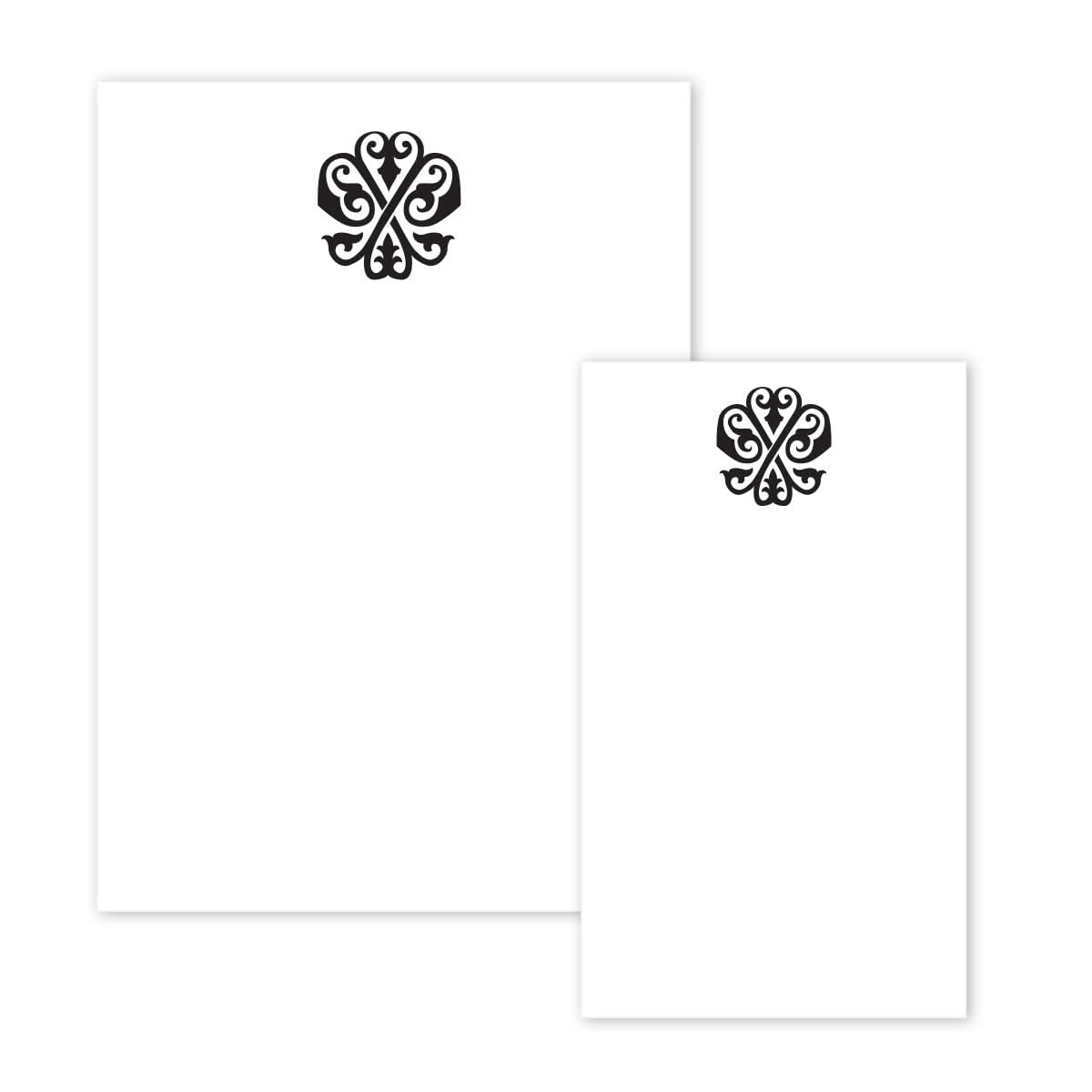 The Gift Bar Notepad Set includes two white letterhead sheets of different sizes, each adorned with a stylized black floral logo at the top center, exuding elegance. Their meticulously crafted design is reminiscent of sophisticated notepads eagerly anticipating your personalized notes.