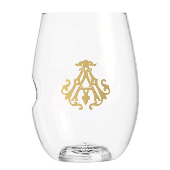 The 1-Letter govino® Stemless Shatterproof Wine glass showcases a gold ornate monogram or logo design on one side. This clear, reusable, and shatterproof glass features a slight indent for ergonomic grip against a plain white background.