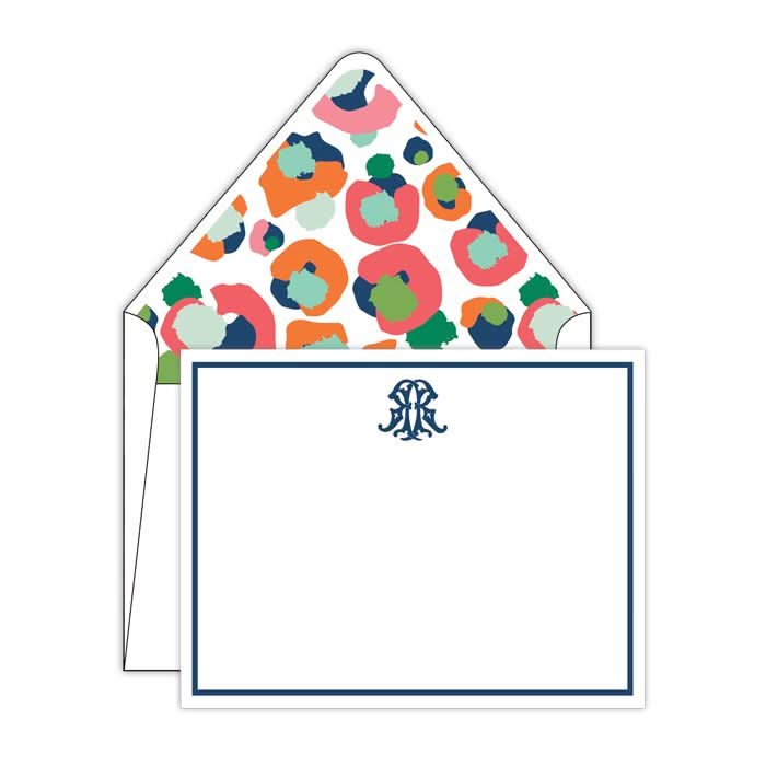 The Multi Spot Cheetah Social Sets from Gift Bar feature a vibrant envelope with an abstract floral design, revealing a white notecard with a striking blue border and a monogram tastefully centered at the top.