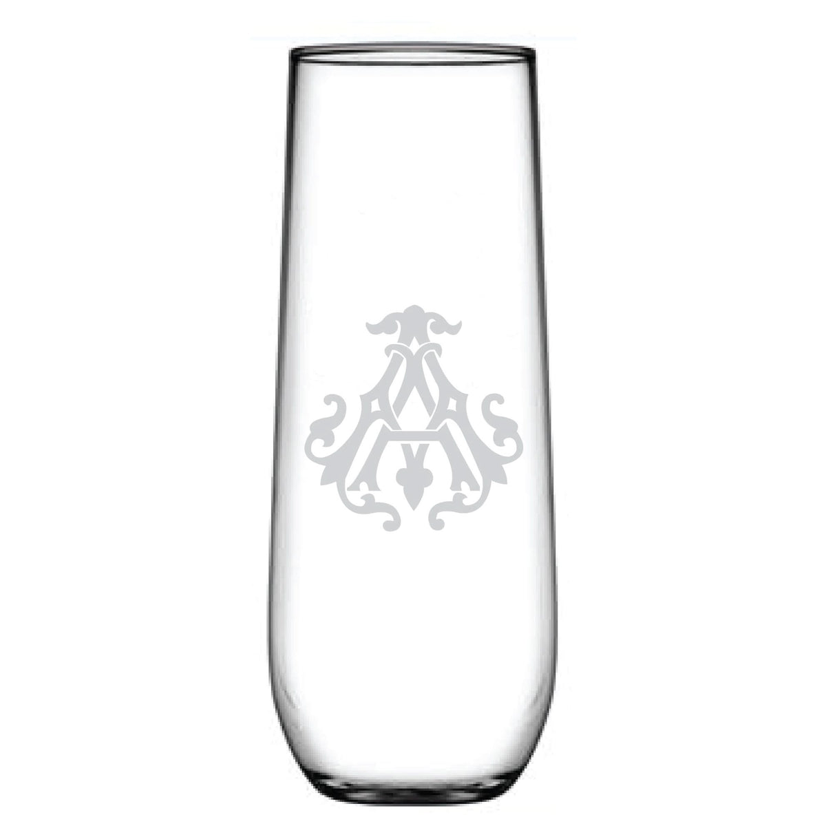 A tall 1-Letter Monogrammed Stemless Champagne Flute features a clear glass with a centrally etched symmetrical emblem and an intricately engraved initial, exuding elegance.