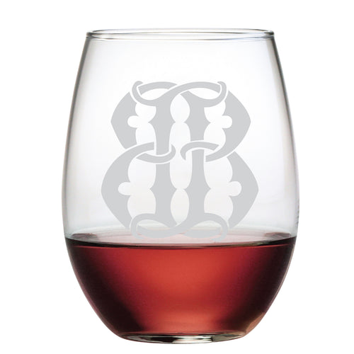The 1-Letter Etched Initial Stemless Wine Glass, featuring an elegant light gray monogram, is filled halfway with red wine and rests elegantly on a plain background, making it a perfect thoughtful gift.