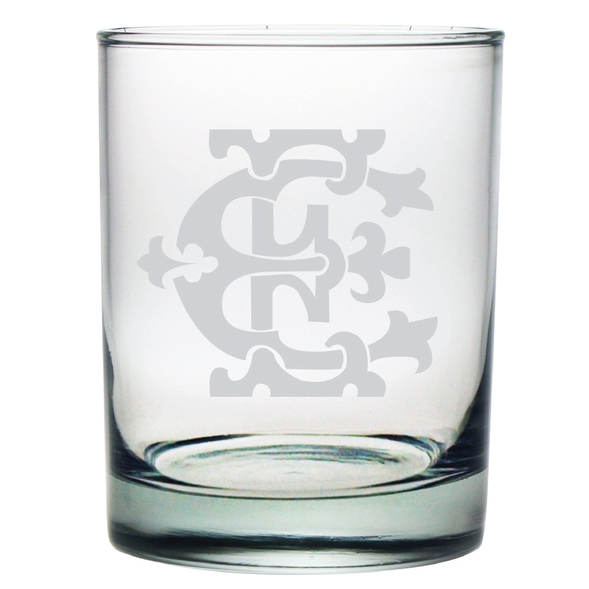 The 1-Letter Monogrammed Lowball Glass is clear with a frosted emblem showcasing an intricate monogram pattern of stylized letters and ornate design. Its empty against a white background, making it a perfect gift for any occasion.