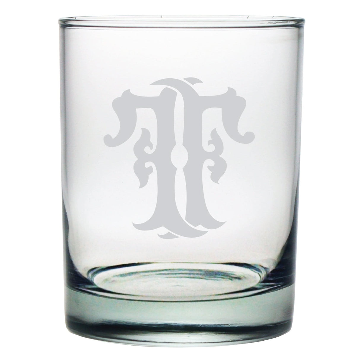 The 1-Letter Monogrammed Lowball Glass features an ornate, decorative letter T etched in a monogram style on its clear, cylindrical surface, making it an elegant gift for any occasion.