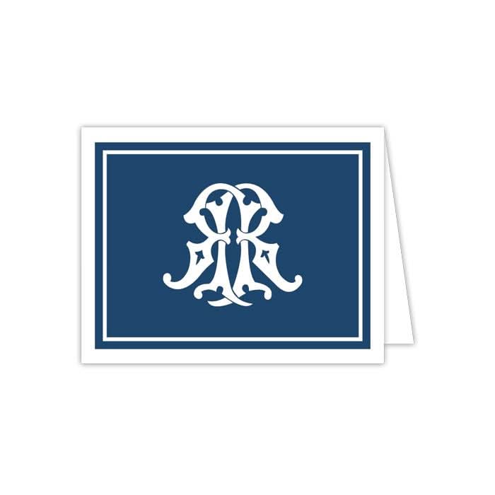 The Gift Bar - Folded Note features a dark blue cover adorned with an elegant white monogram design at the center. Part of a set of 10 notecards, it is slightly opened to the right, revealing its blank white interior alongside matching envelopes.