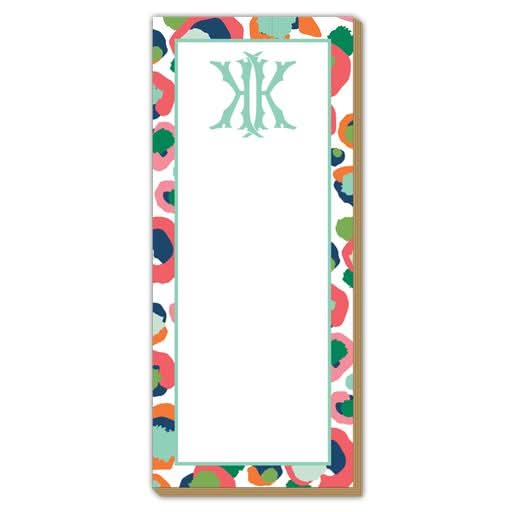 The Gift Bar - Luxe Skinny Pad is a 3.5 x 8.5” notepad on durable 100# card stock, featuring a gold-outlined abstract leopard print border and a pale green decorative monogram at the top of the blank center.