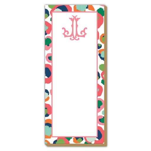 The Gift Bar - Luxe Skinny Pad is a rectangular notepad, sized at 3.5 x 8.5 inches, with a vibrant abstract border in shades of pink, orange, blue, and green. Made from high-quality 100# card stock, the notepad features a pristine white center adorned with a decorative pink letter J at the top.
