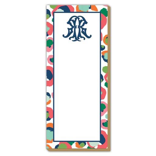 Introducing the Gift Bar - Luxe Skinny Pad: a 3.5 x 8.5 notepad featuring a decorative monogram at the top, printed on durable 100# card stock. The pad is adorned with a vibrant border of red, orange, green, blue, and pink spots set against a white background, with its center left blank for your notes.