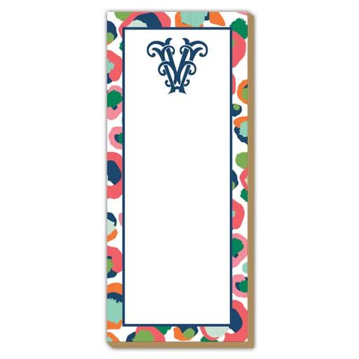 The Gift Bar - Luxe Skinny Pad is a 3.5 x 8.5 rectangular notepad with a colorful abstract border, a large ornate navy blue V at the top center, printed on sturdy 100# card stock. The middle area is blank for notes.
