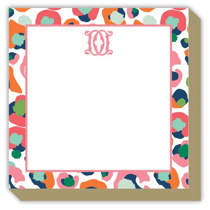 Introducing the Gift Bar - Luxe Notepad, a charming square notepad measuring 5.5 x 5.5 inches. It boasts a vibrant abstract border with pink, orange, blue, and green designs. The center is left blank and adorned with a decorative initial "O" at the top, containing 65 sheets of premium paper perfect for jotting down notes or creating doodles.