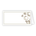 The Neutral Spot Cheetah Place Cards, available in a pack of 10, are blank and rectangular with a subtle beige and gray floral pattern in the top right corner and a thin beige border. Measuring 2.25 x 4.5 inches when folded, they stand slightly open, making them perfect as elegant place cards for any event.