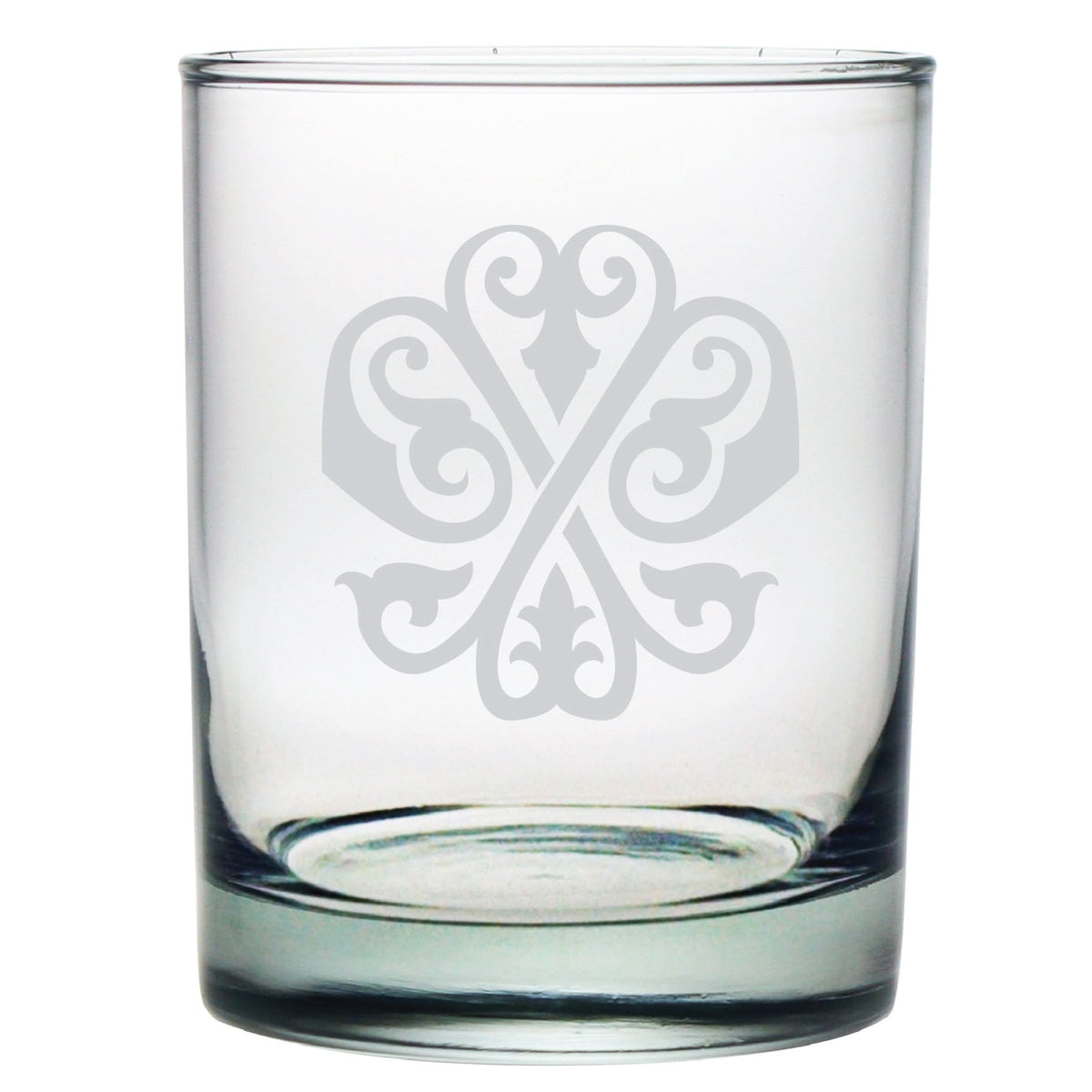 The 1-Letter Monogrammed Lowball Glass features an elegant, symmetrical design etched on the front with intricate swirling patterns forming a monogram-style cross, making it a perfect gift for any occasion.