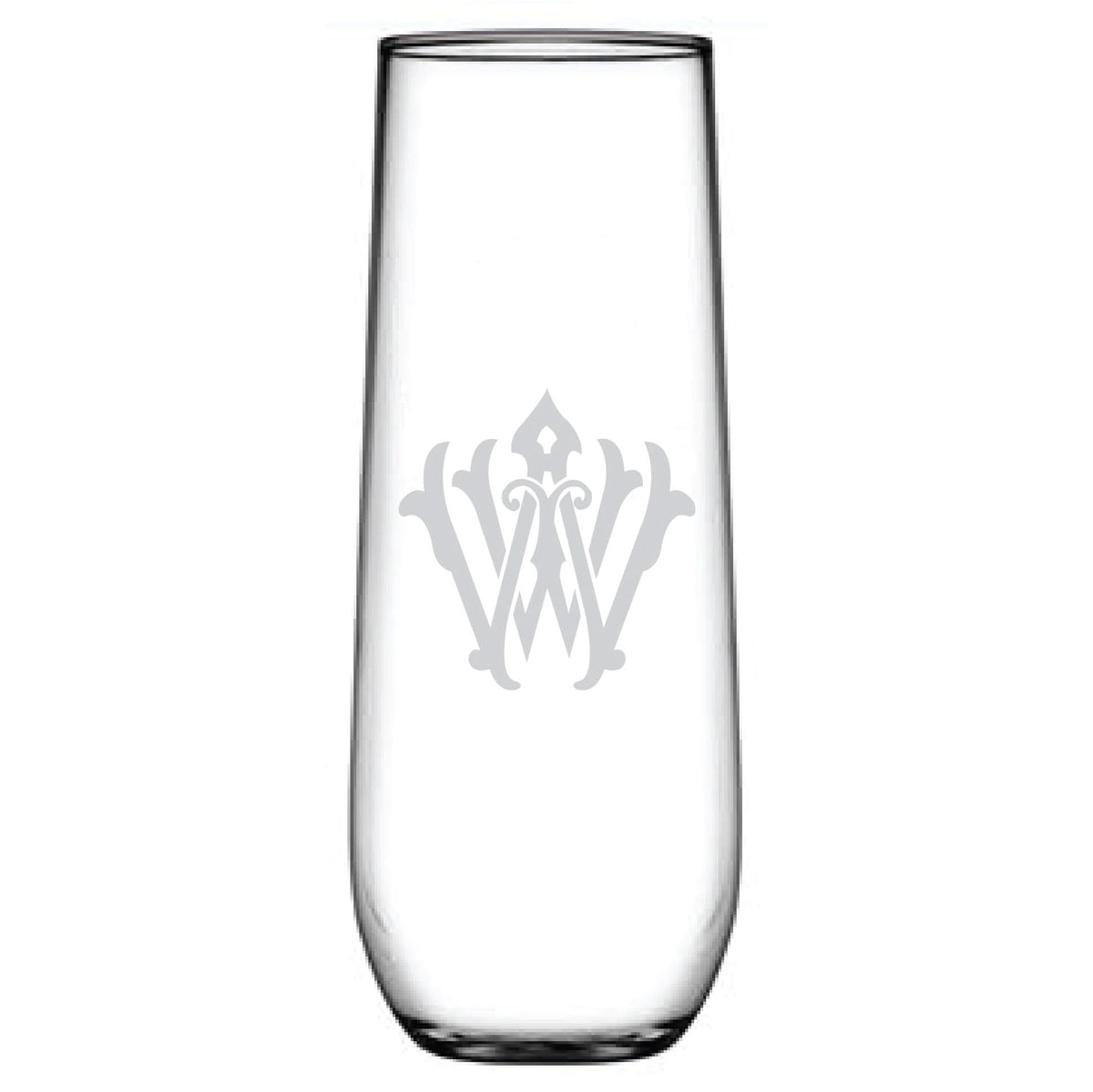 A 1-Letter Monogrammed Stemless Champagne Flute, featuring an etched decorative emblem with letters W and V, shows off a vintage style with ornamental details on a clear tall glass against a plain white background.
